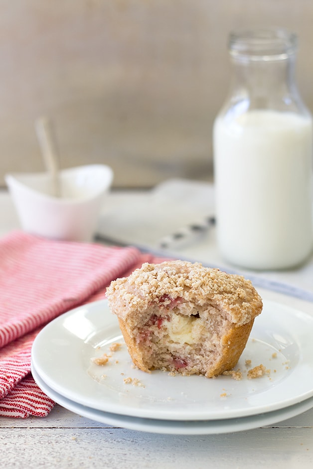 Strawberry Cream Cheese Muffins - fluffy strawberry-studded muffins stuffed with a sweet cream cheese filling and topped with a light crumble topping. | brighteyedbaker.com