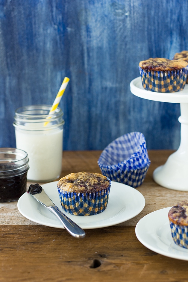 Blueberry Jam-Swirled Buttermilk Muffins - Buttermilk muffins flecked with vanilla bean and swirled with sweet blueberry jam - like a classic pancake meal in muffin form. | www.brighteyedbaker.com