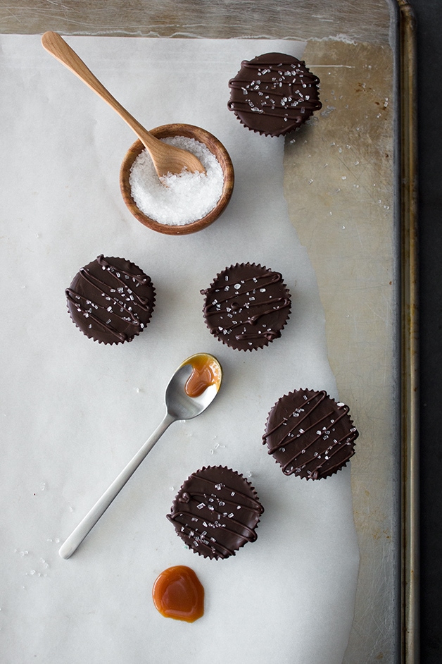Boozy Chocolate Caramel Cups - dark chocolate cups filled with a rich rum caramel and topped with a sprinkle of sea salt.