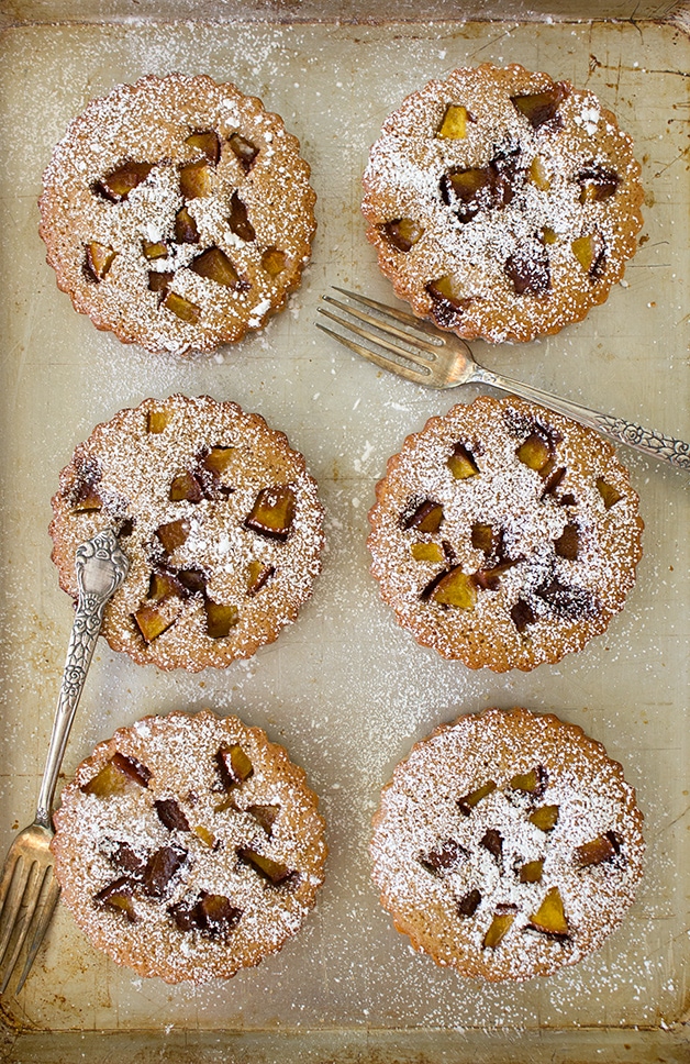 Peach Financiers - classic French brown butter teacakes with slightly crisp edges and a perfectly soft and moist crumb, filled with a nutty sweet flavor and juicy fresh peaches. | www.brighteyedbaker.com