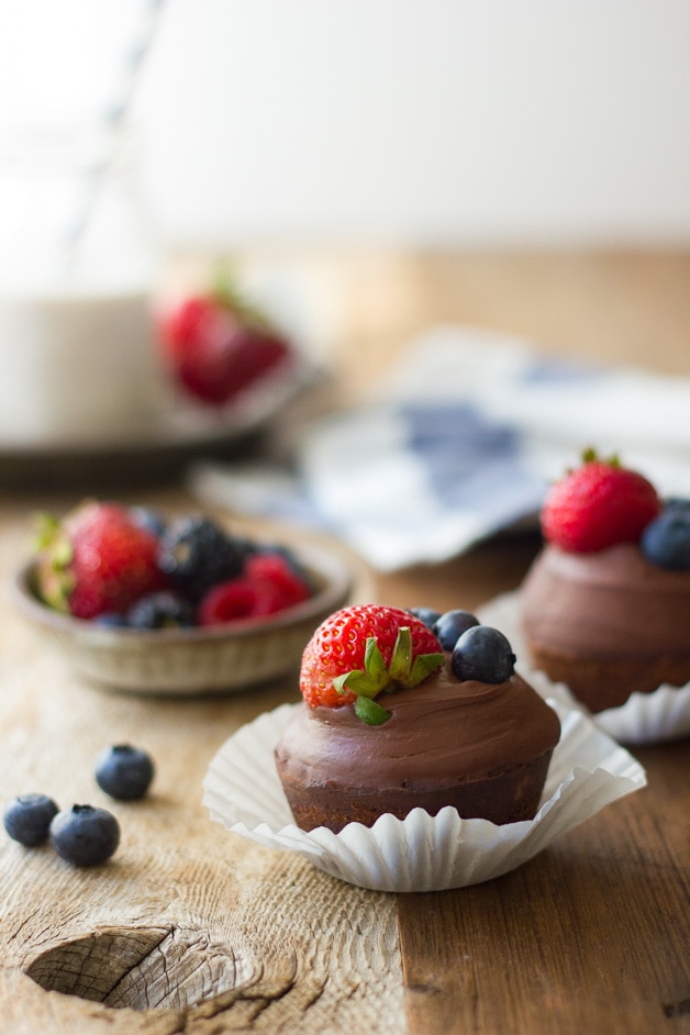 Hazelnut Financier Cupcakes with Whipped Chocolate Ganache - Light & nutty french teacakes topped with a silky coconut milk ganache and fresh berries. A show-stopper dessert that won't destroy your clean eating! {gluten-free, dairy-free, refined sugar-free}