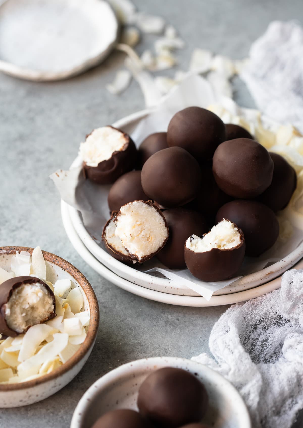 Easy-to-make coconut bites dipped in dark chocolate -- a perfect guilt-free sweet treat! {keto, gluten-free, vegan}