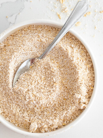 Close up of homemade oat flour in a bowl.