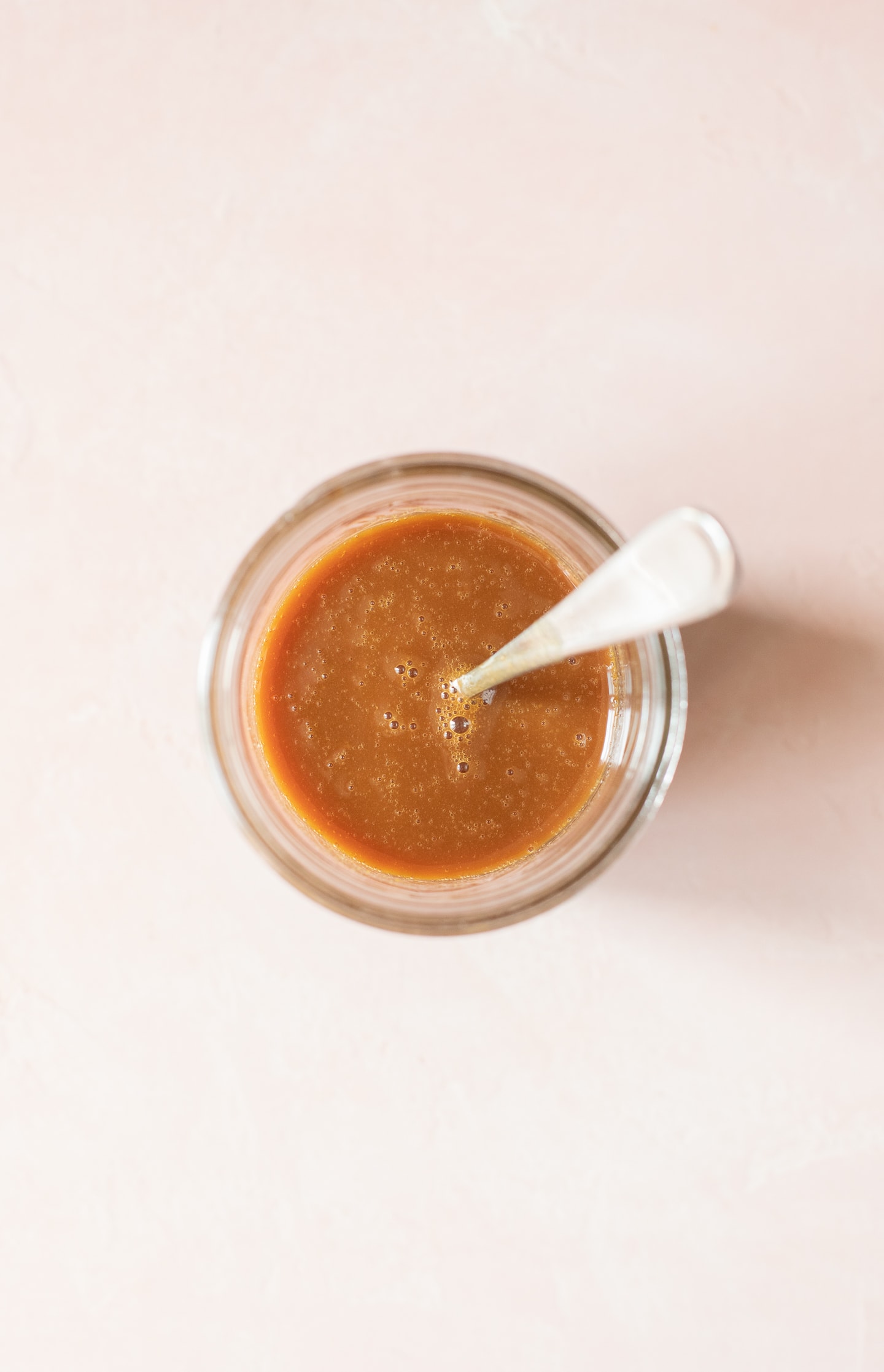 Overhead view of homemade caramel sauce in a jar