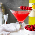 Raspberry limoncello vodka cocktail served in a martini glass.