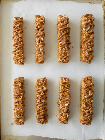 Salted Caramel & Candied Pecan Biscotti - crunchy candied pecans, a sweet caramel drizzle, and a sprinkle of sea salt turn simple biscotti into an extra-tempting treat. | www.brighteyedbaker.com
