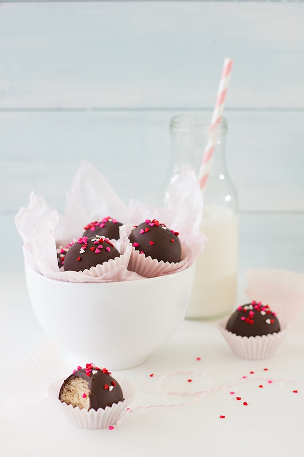Sugar Cookie Dough Truffles: Bite-sized balls of sugar cookie dough wrapped in a rich coating of chocolate - the perfect treat for your sweet someone! | www.brighteyedbaker.com