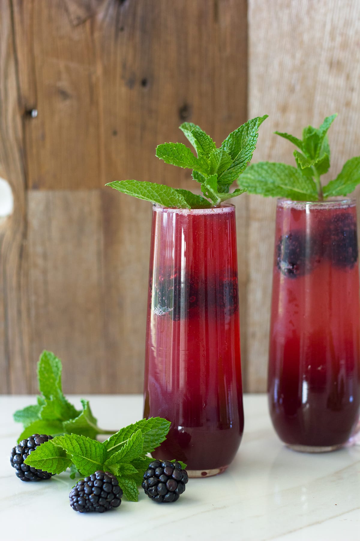 Two mimosas with blackberries and mint.
