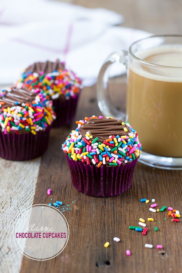 Classic Chocolate Cupcakes - moist chocolate cupcakes topped with a rich chocolate buttercream and tons of rainbow sprinkles. | www.brighteyedbaker.com