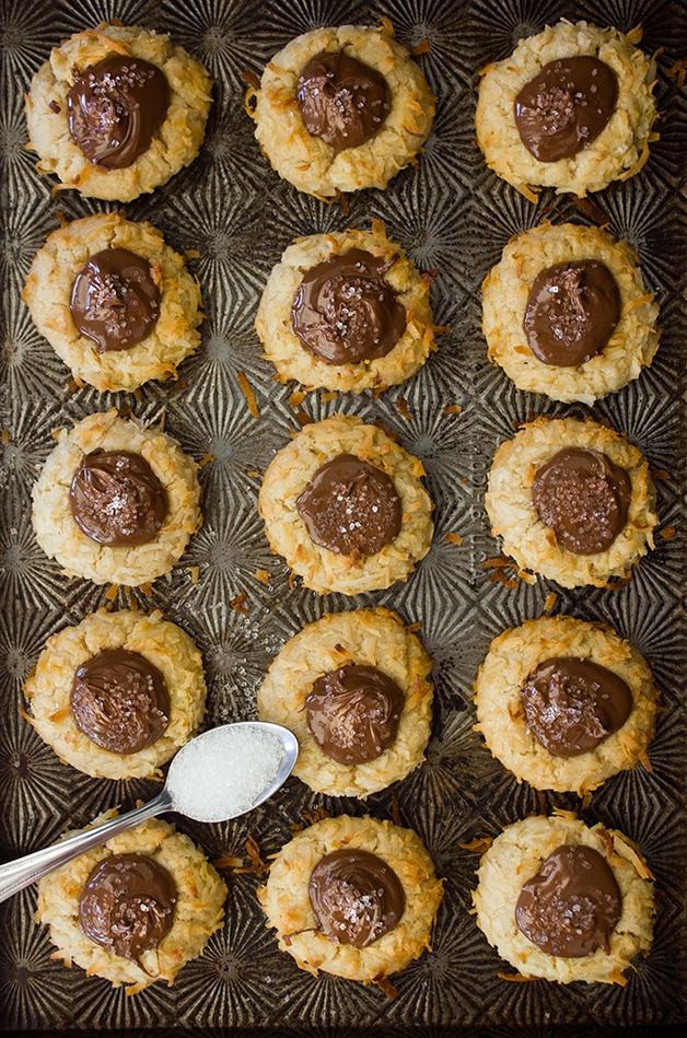 Nutella-Filled Coconut Thumbprint Cookies - Like a shortbread cookie-turned-macaroon, with sweet, toasted coconut on the outside and a dollop of Nutella in the middle for a nutty chocolate twist. | www. brighteyedbaker.com