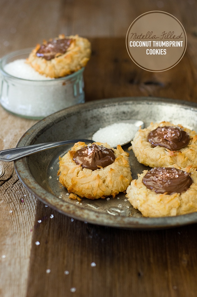 Nutella-Filled Coconut Thumbprint Cookies - Like a shortbread cookie-turned-macaroon, with sweet, toasted coconut on the outside and a dollop of Nutella in the middle for a nutty chocolate twist. | www. brighteyedbaker.com