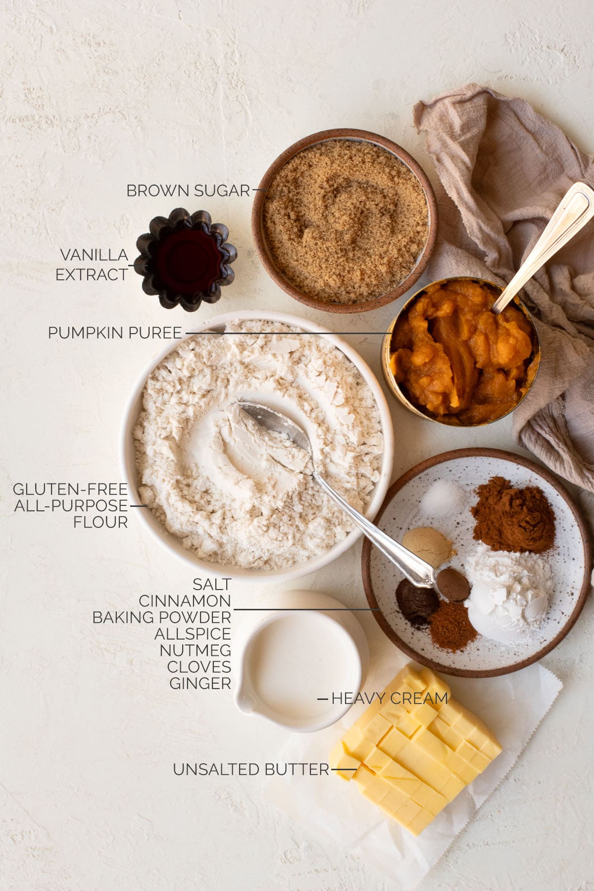 Brown sugar, pumpkin puree, vanilla extract, flour, heavy cream, butter, baking powder, salt, and spices for pumpkin scones.
