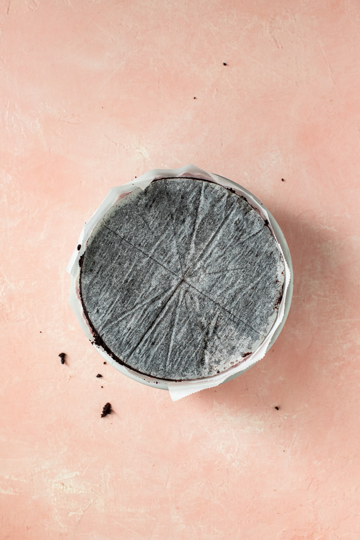 Single cake layer placed parchment side-up in a cake pan.