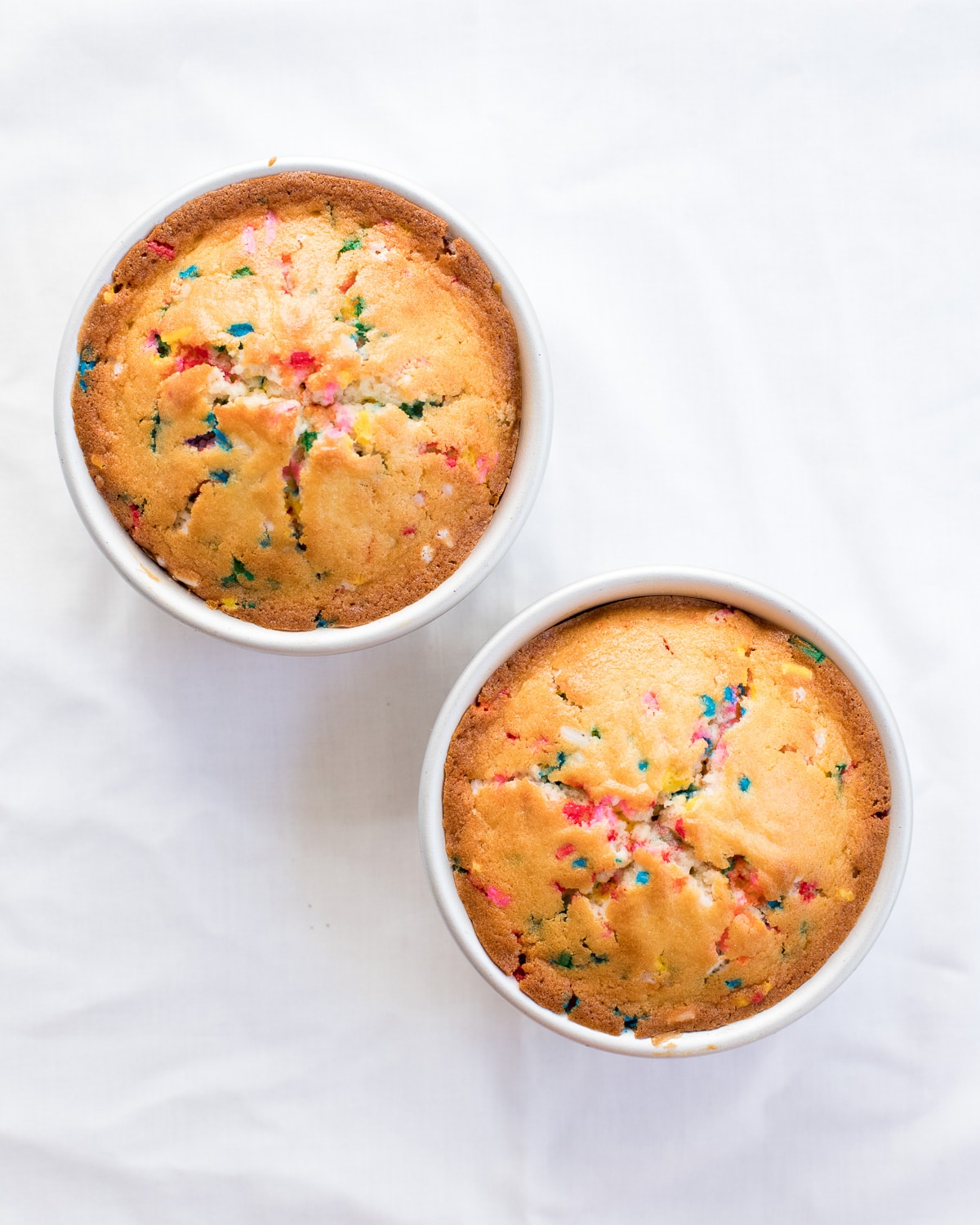 Two small funfetti cakes in cake pans