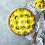 Kiwi lime pie garnished with green and yellow kiwi.