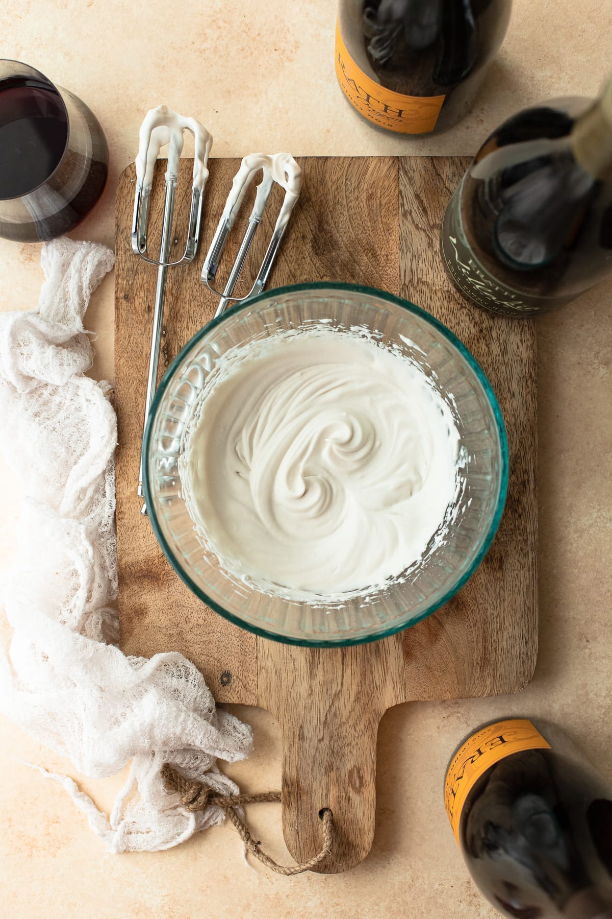 A bowl of vegan whipped cream made from coconut milk on a wooden board.