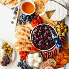 Charcuterie board with individual portions on small plates.