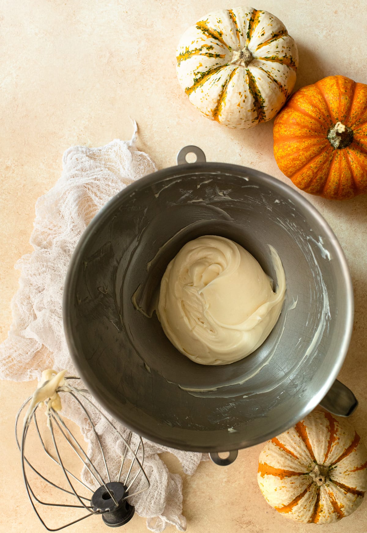 Homemade cream cheese frosting in a mixing bowl.