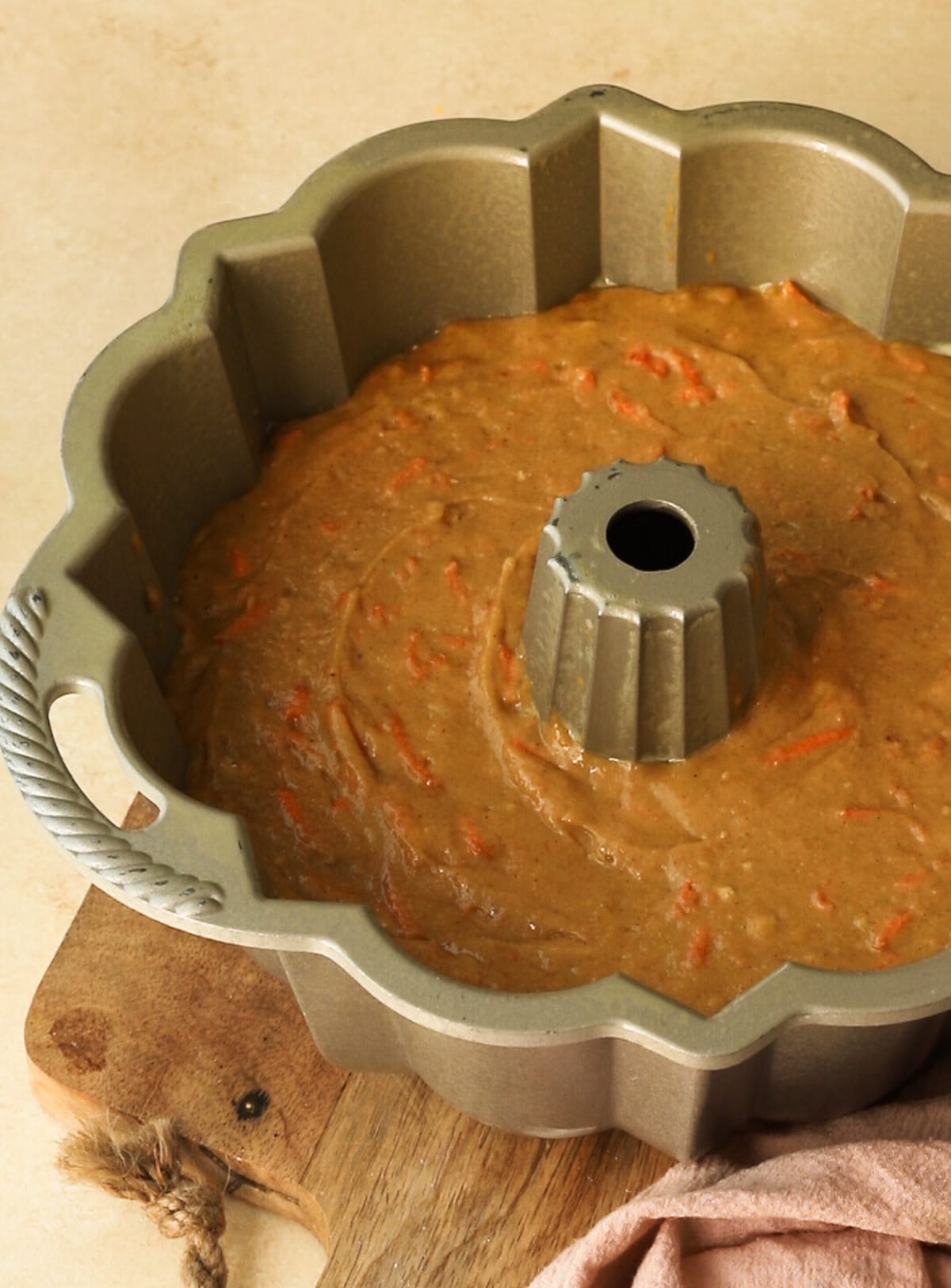 Carrot cake batter in a bundt pan.