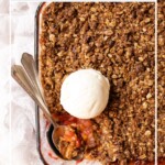 Crumble in a baking dish topped with a scoop of ice cream, with text overlay of recipe name.