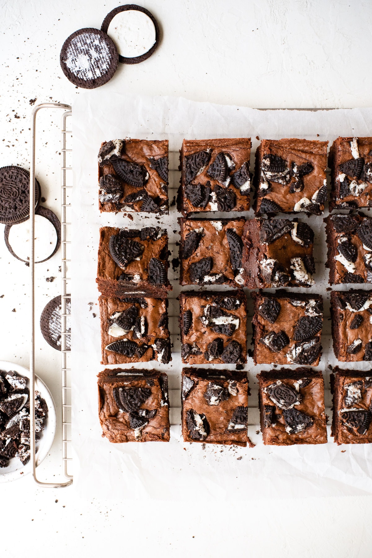 Oreo brownies sliced and set on a parchment-lined wire rack.