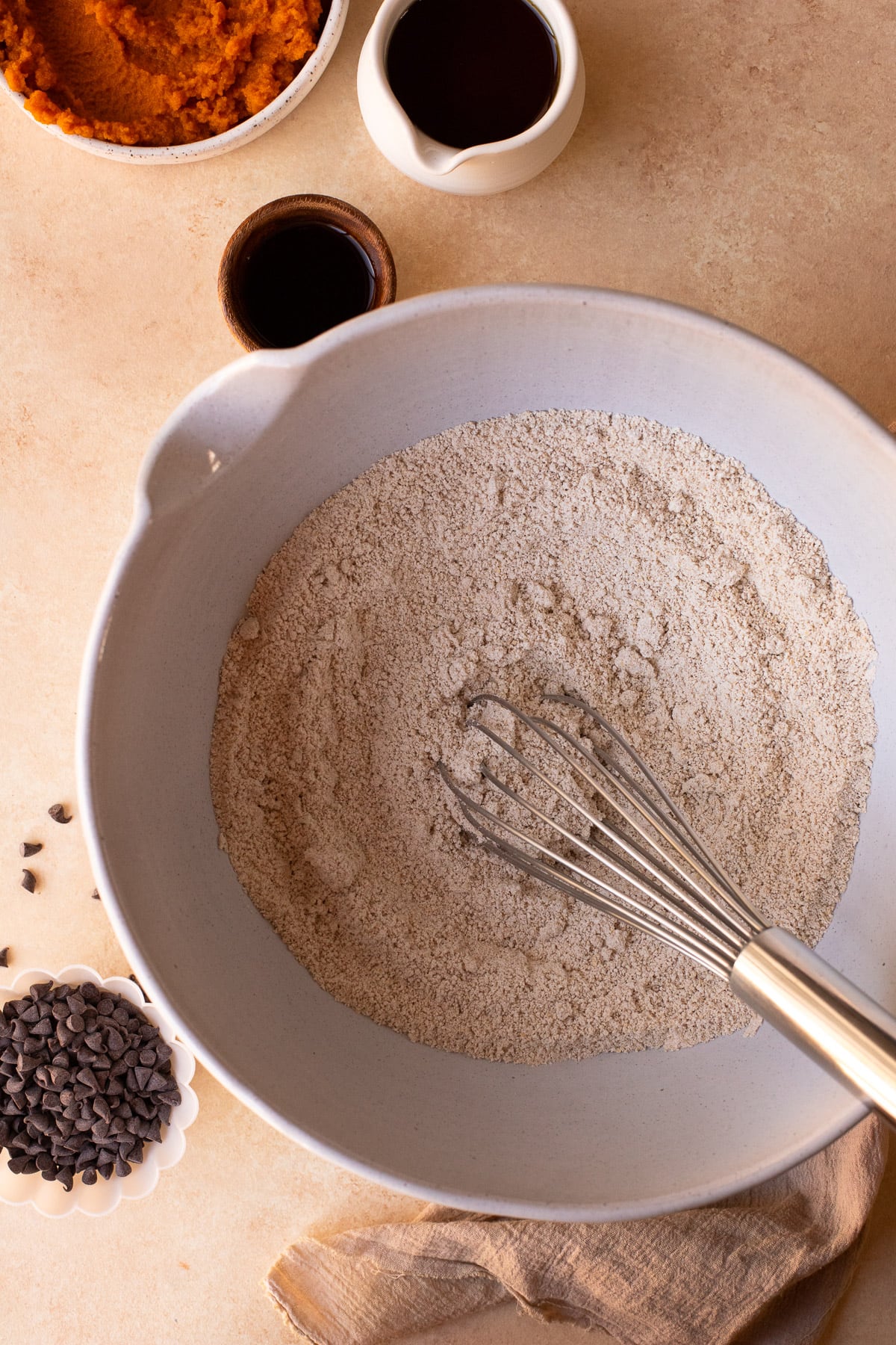 Dry ingredients being whisked together in a large bowl.