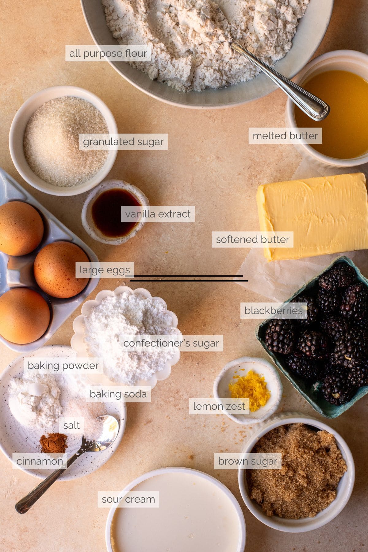 Labeled ingredients for making blackberry muffins with a crumb topping and blackberry drizzle.