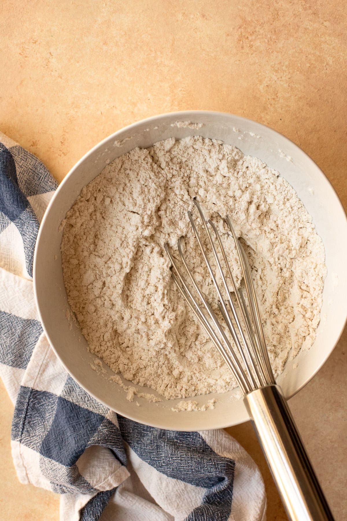 Dry ingredients for muffins whisked together in a bowl.