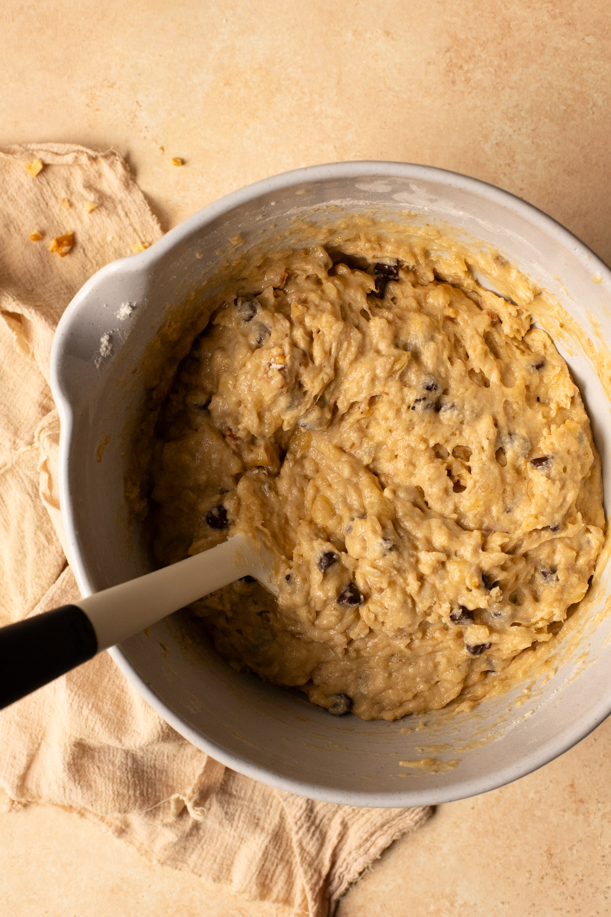 Banana bread batter with walnuts and chocolate chips mixed in.