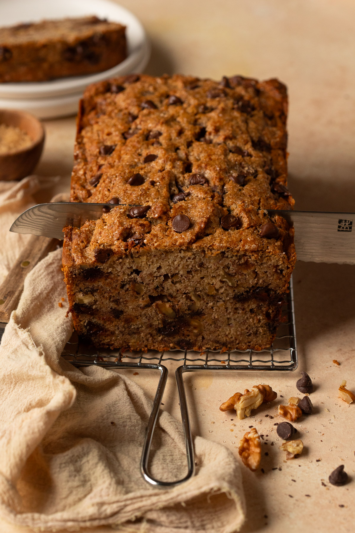 A loaf of banana bread being sliced.