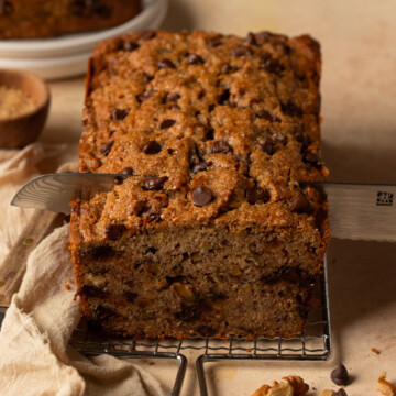 A loaf of banana bread being sliced.