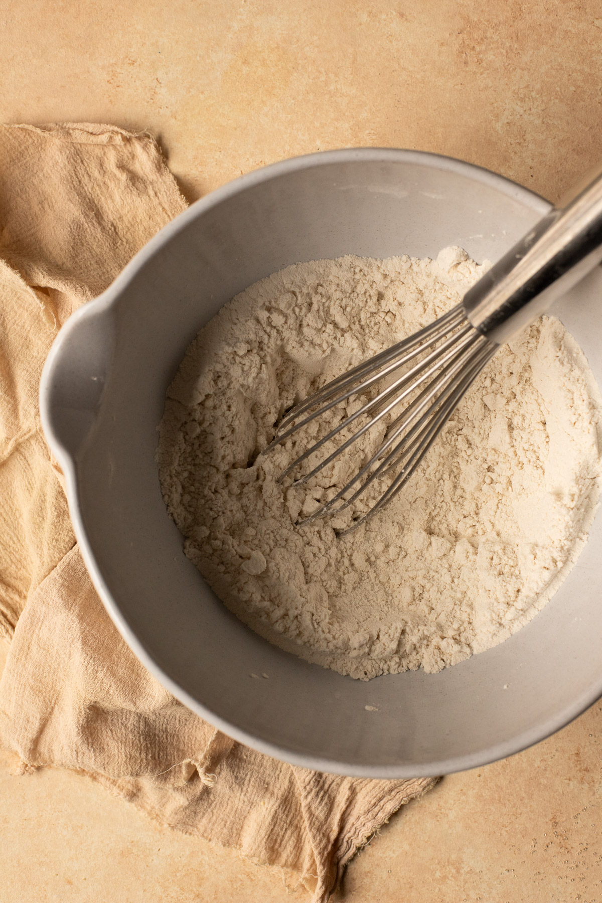 Flour, baking soda, and salt mixed together in a bowl.